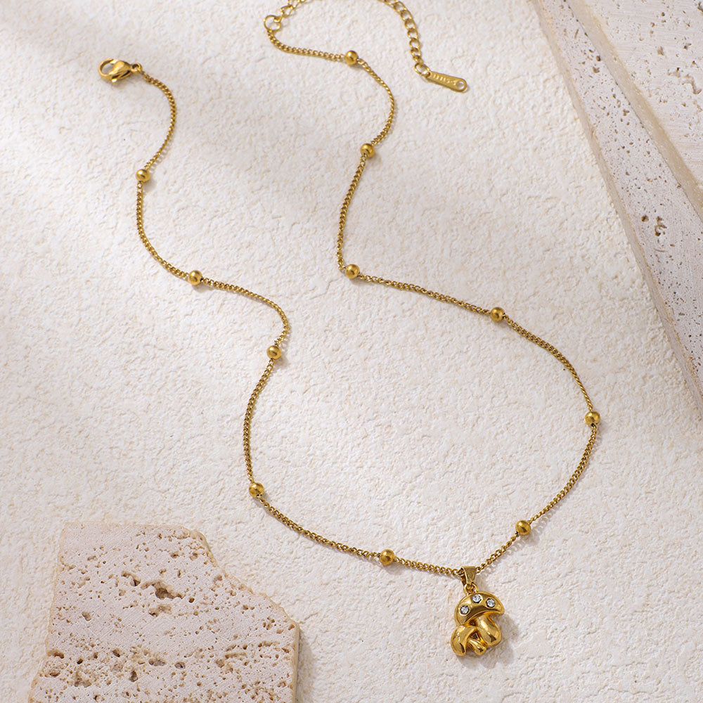 Collana con pendente a forma di fungo in acciaio inossidabile con strass intarsiati